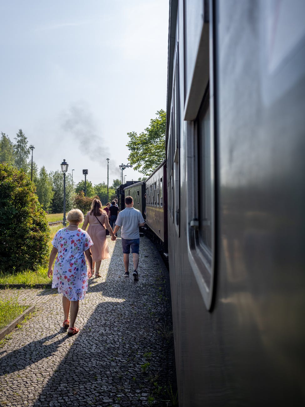 family strolling along historic train in zittau
